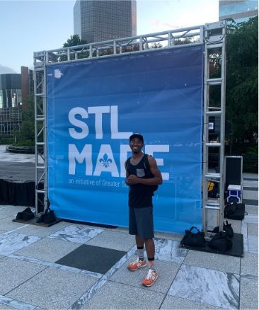 Ardimus Caldwell Jr. in front of an STL Made banner in downtown St. Louis