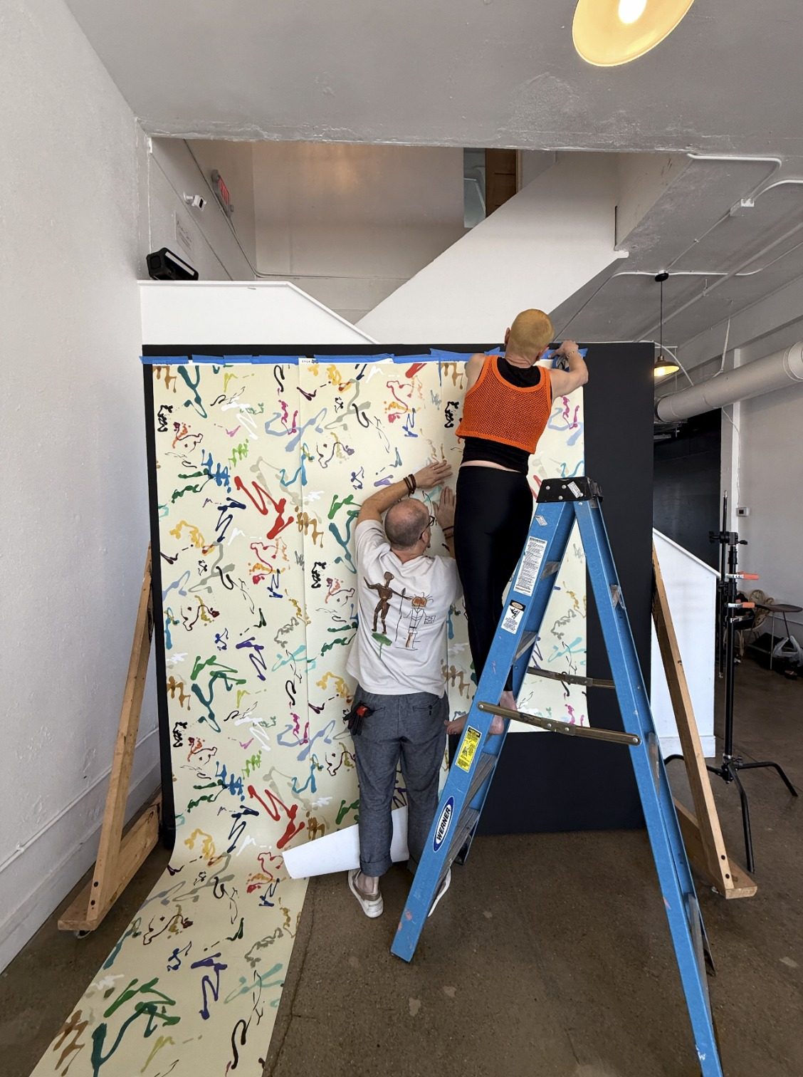 Installing an Ever Atelier wallcovering in the studio