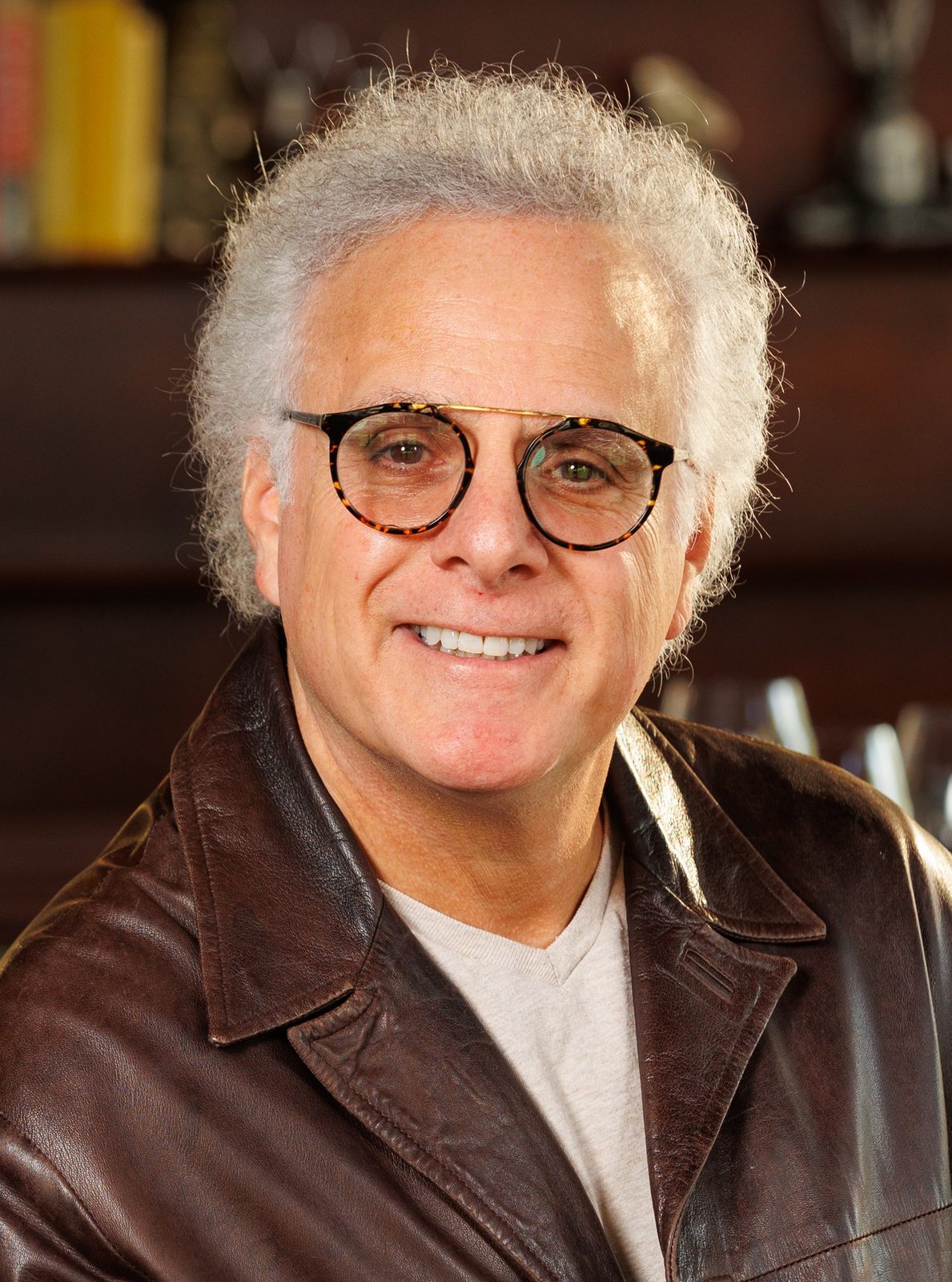 Benson J. Fischer, founder and CEO of ZivZo Marketing Group, smiling in a brown leather jacket