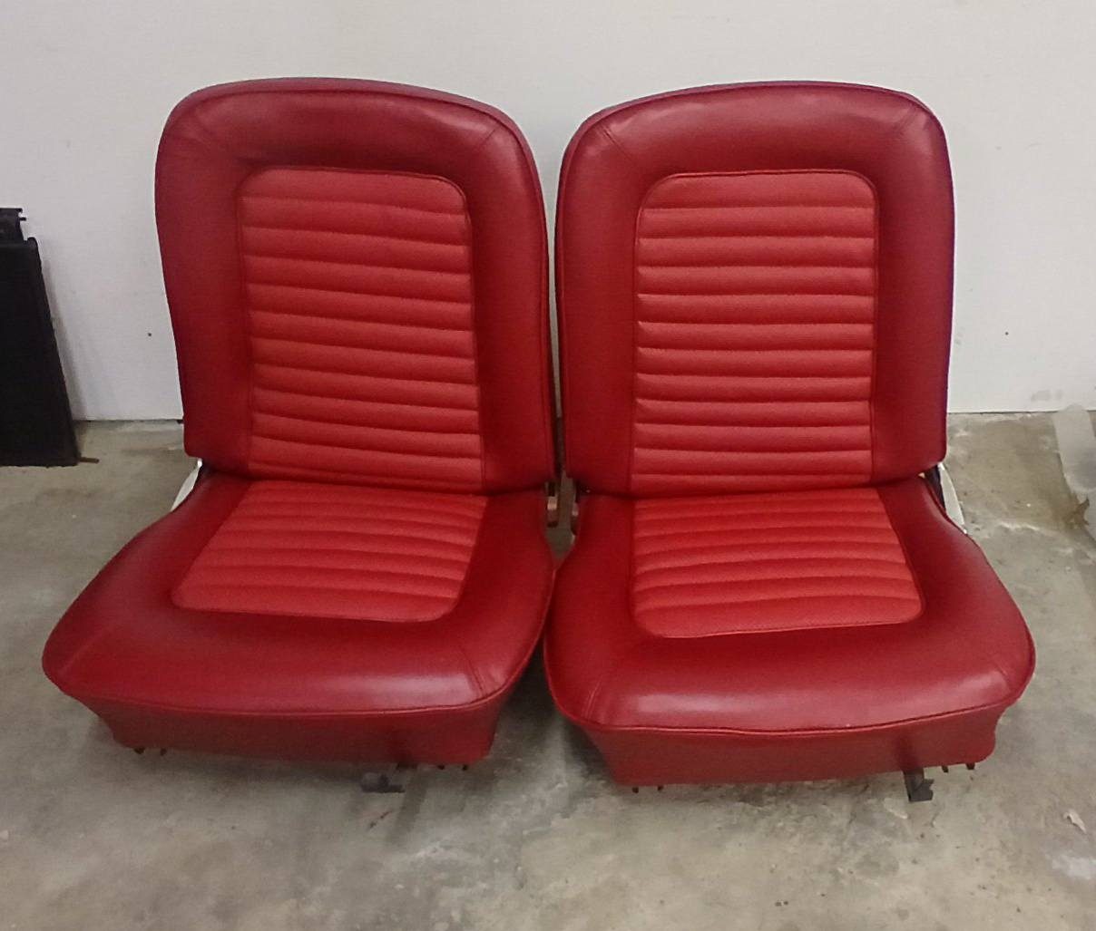 A pair of 1966 Mustang bucket seats reupholstered in red pleated vinyl by Plummer Upholstery