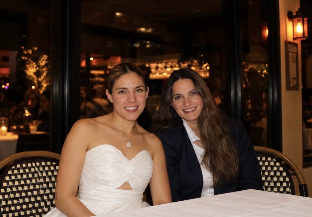 Maria Adelaida Suarez, co-founder of Bringing Happiness Foundation, with her sister and co-founder Lina Suarez at a restaurant table