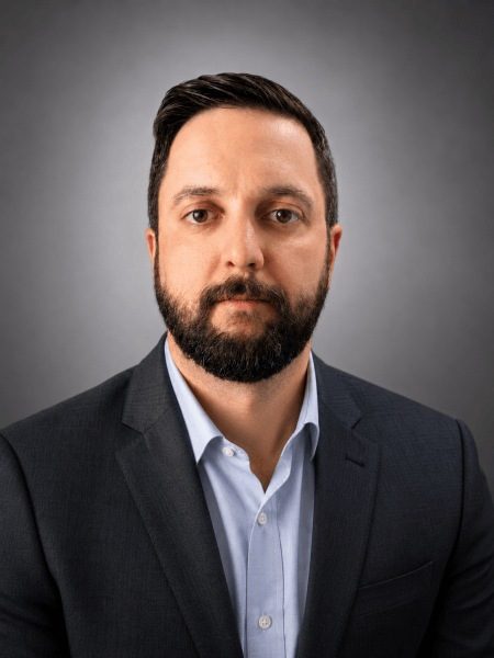Mark Schneider, founder of Patrol Guard Security Services, in a dark suit and light blue shirt