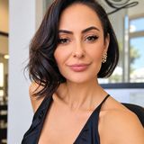 Anna Agajanyan, owner of The Look Hair Salon, smiling in a black dress inside her Glendale salon