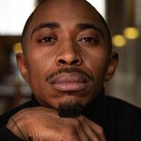Ardimus Caldwell Jr., founder of Whois, in a black turtleneck with his chin resting on his hand