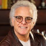 Benson J. Fischer, founder and CEO of ZivZo Marketing Group, smiling in a brown leather jacket