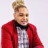Dr. Jesse Sanders, founder of Redefined Behavioral Health & Wellness, in a red blazer