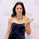 Kaitlin Mahony, founder of Sketchbook, holding her illustration markers in a navy floral dress at a Beau Truesdale Wedding Venues event on the Jersey Shore