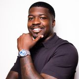 Karahn Alston, founder of Keeping Hopes Alive, smiling in a dark polo shirt with his hand at his chin