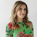 Lisa Edwards, president and master colorist of Sunday Salon, in a green floral top against a white wall