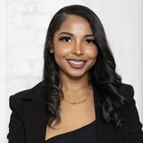 Miracle Flowers, founder of The Miracle Agency, smiling in a black blazer
