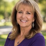 Paris Heinen, founder of Always On Your Side Coaching, smiling outdoors in a purple top