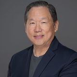 Will Lukang, founder of Kairos Elite Partnership, studio portrait in a navy blazer